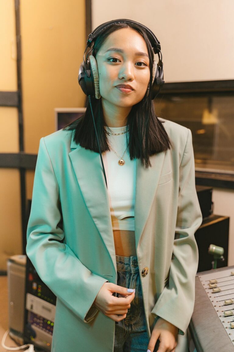 Young woman with headphones in a modern recording studio.